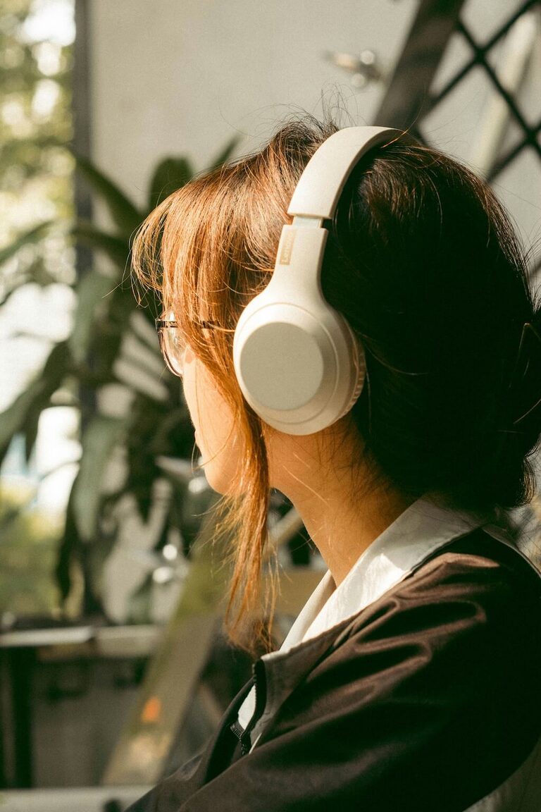 Woman wearing headphones and listening to audio